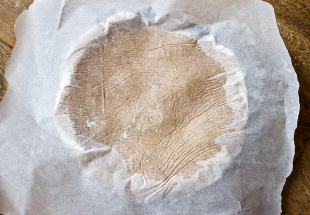 tarte tatin crust dough over tin covered in baking parchment