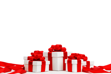 Holiday presents wrapped in white paper with red ribbons, isolated on white