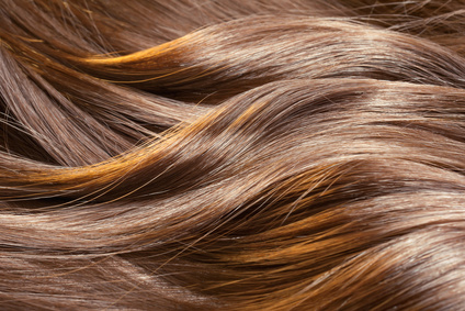 Beautiful healthy shiny hair texture with highlighted golden streaks