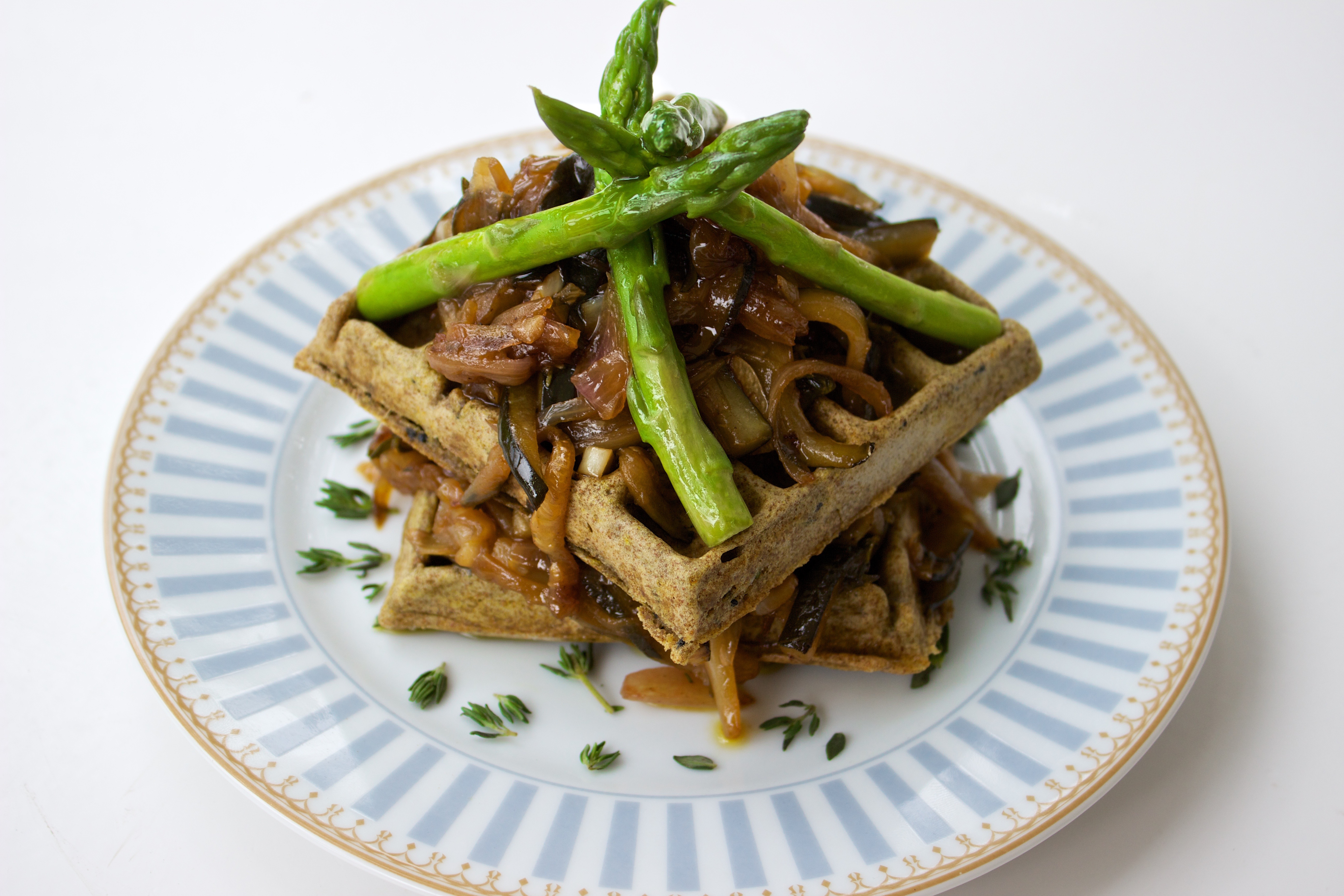 savoury waffles with asparagus on a blue plate and white background