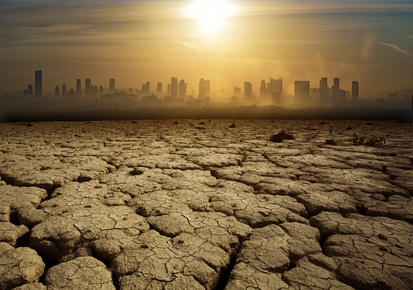 arid land with buildings in the distance