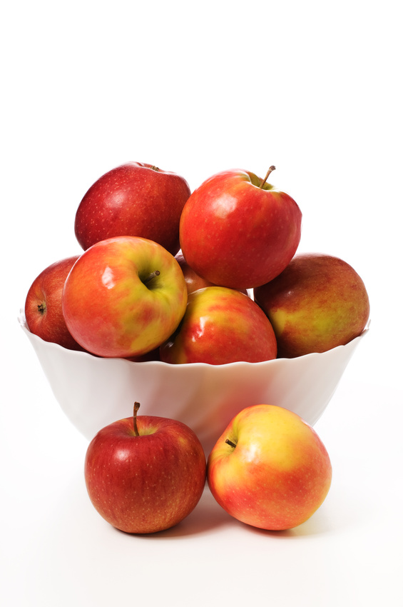 red apples in a while bowl on a white background
