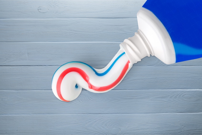 toothpaste squeezed onto a blue wooden background